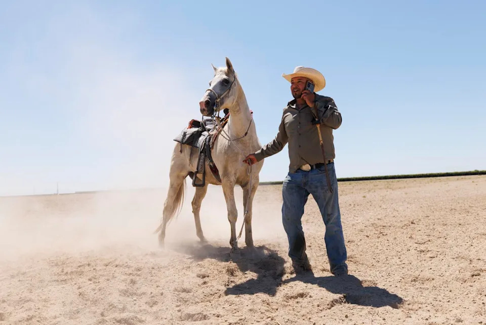 Emilio Carranza Sr. calls for a backup saddle when a stirrup breaks.