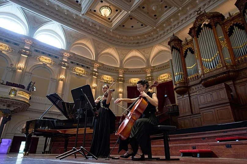Violinist Hyunjin Cho, left, and cellist Efstratia Chaloulakou perform for students studying with music at Concertgebouw in Amsterdam, Netherlands, on 5 March 2026.