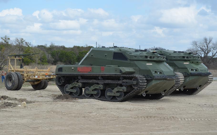 Two unmanned vehicles sit side by side.