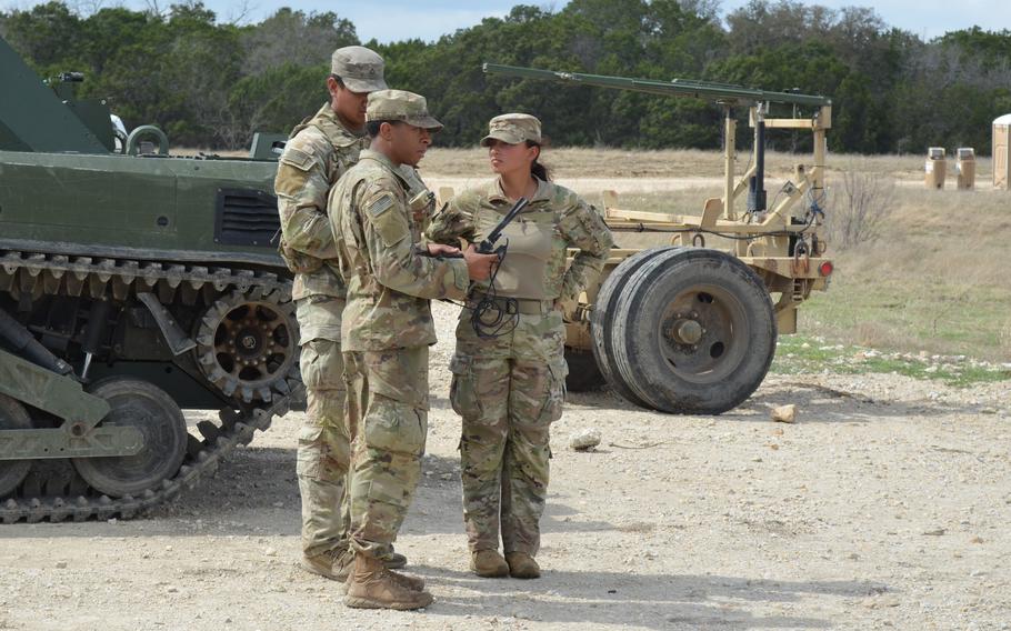 A soldier uses a controller to guide a drone.