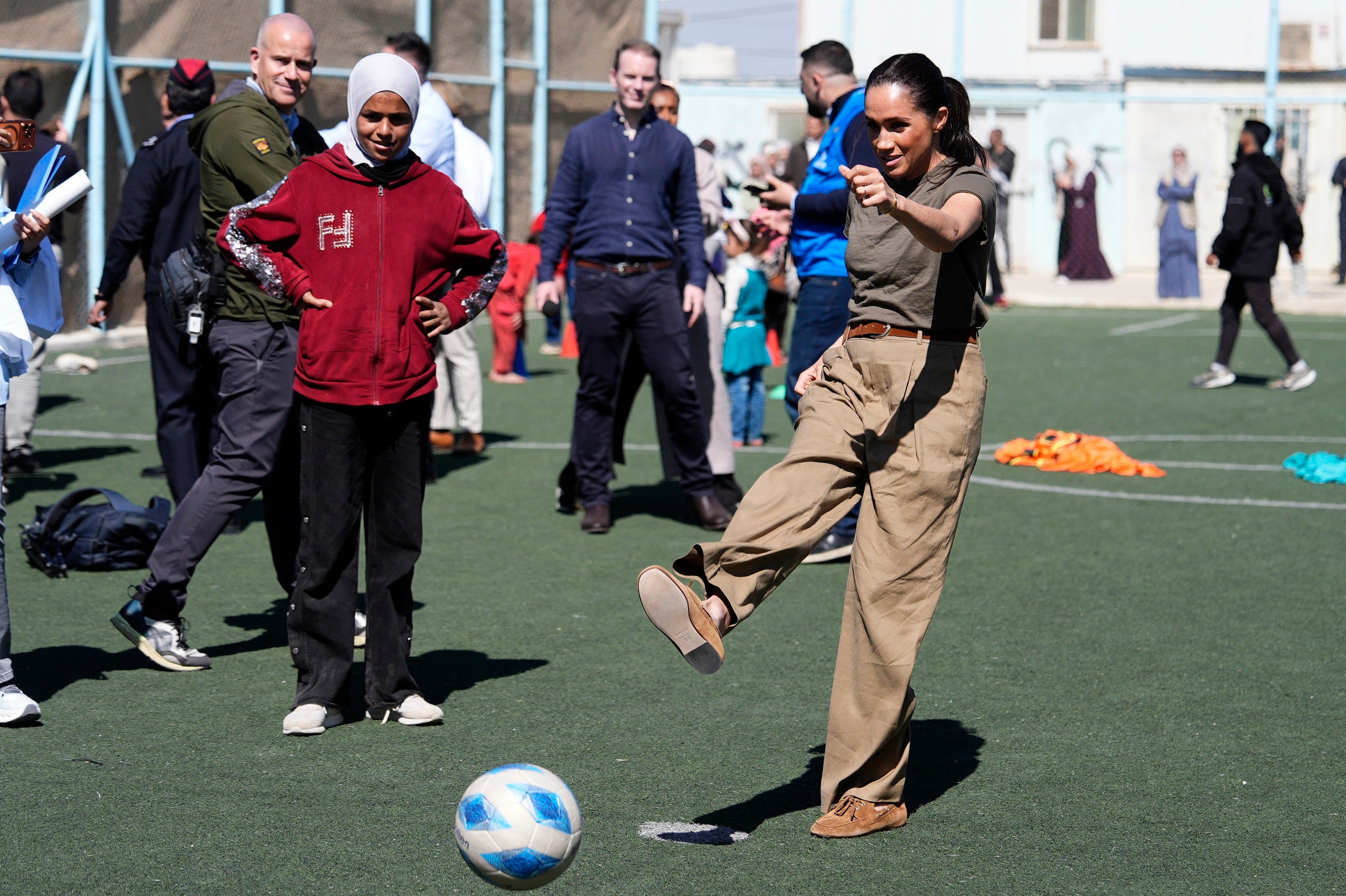 The Duchess of Sussex takes a penalty during a visit to the QuestScope Youth Centre at the Za'atari refugee camp in northern Jordan