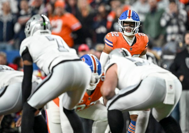 Brandon Jones (22) of the Denver Broncos eyes Geno Smith (7) of the Las Vegas Raiders during the first quarter at Empower Field at Mile High Stadium on Thursday, Nov. 6, 2025. (Photo by AAron Ontiveroz/The Denver Post)