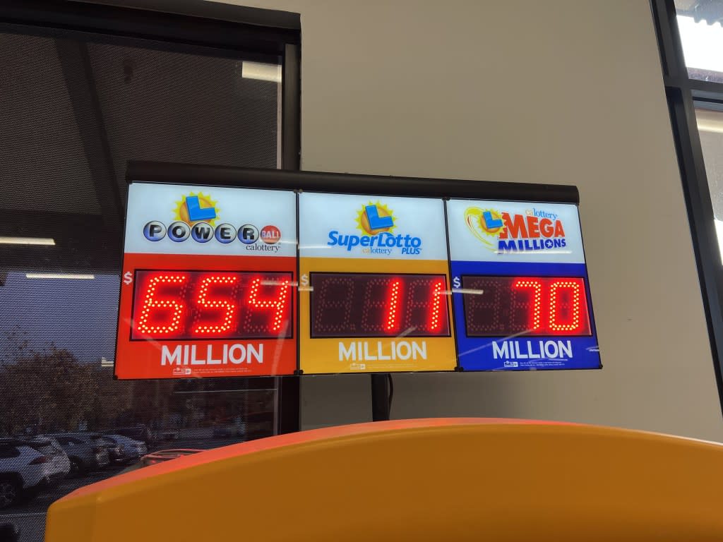 A digital display shows Lottery Powerball, SuperLotto Plus and Mega Millions jackpot amounts in Lafayette, CA. Gado via Getty Images