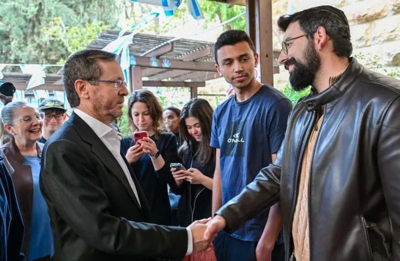 Israel President Isaac Herzog gets to know new immigrants from Jerusalem absorption center, Ulpan Etzion. March 18, 2026. (credit: KOBI GIDEON/GPO)