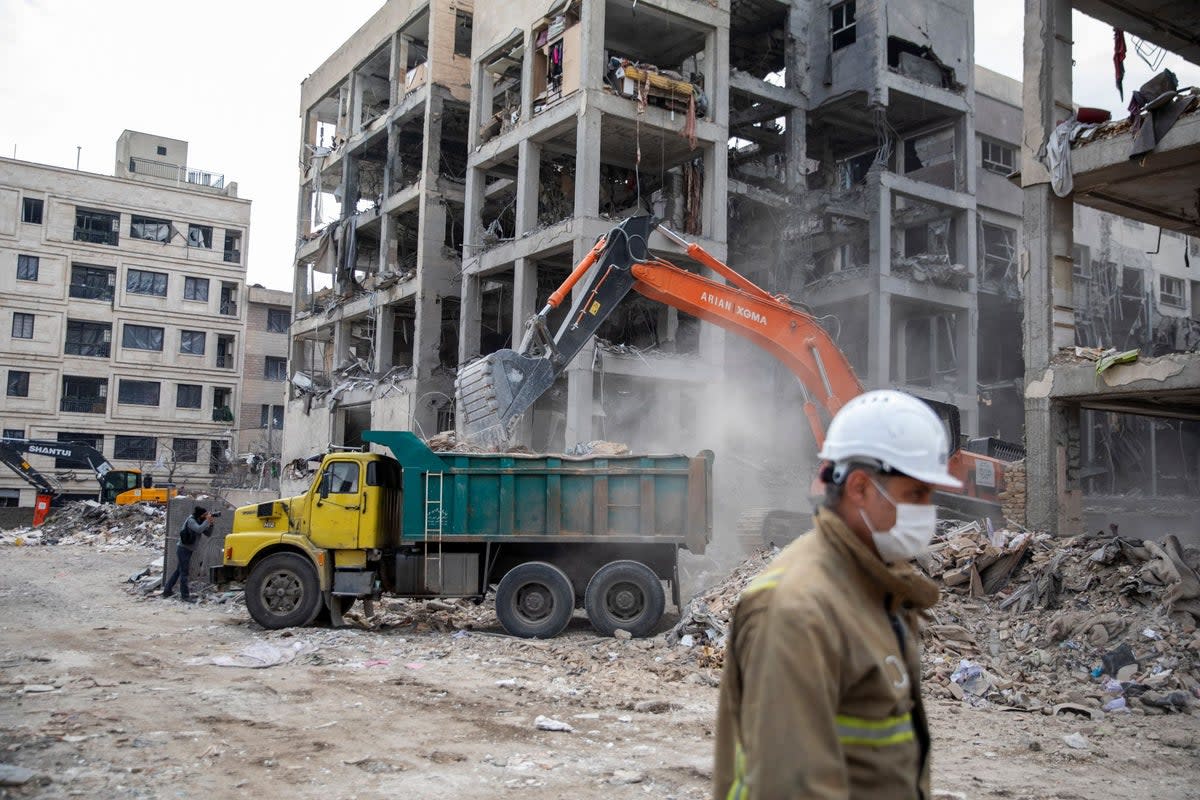 Rubble is collected from residential buildings destroyed by US and Israeli attacks in eastern Tehran on 12 March 2026 (Getty)