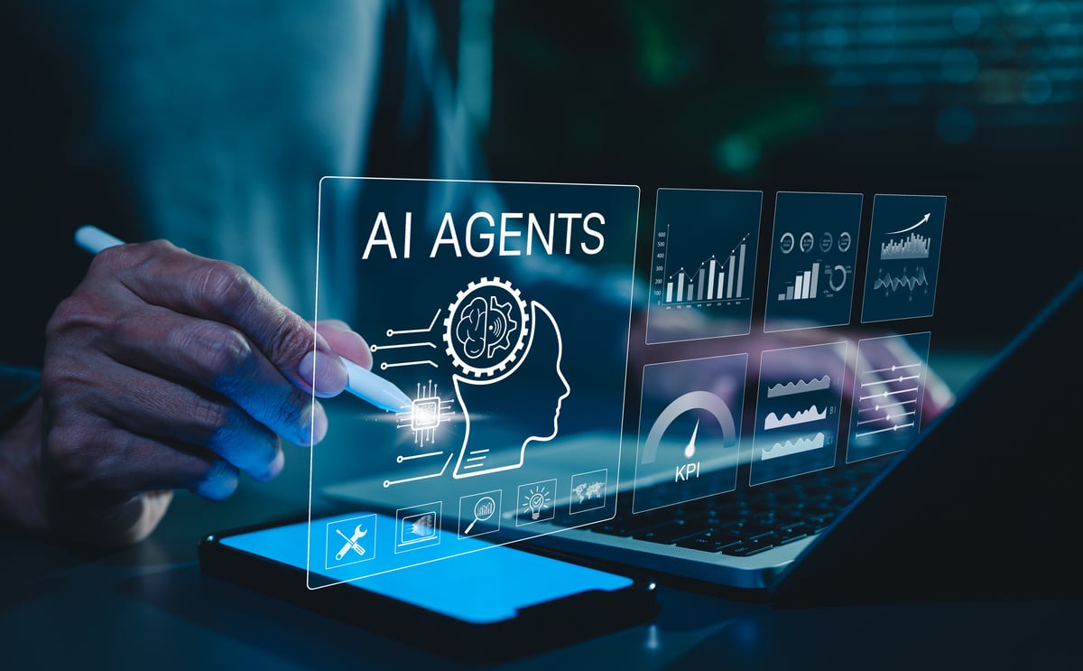 A man writing on a screen with the word AI Agents above a human head.