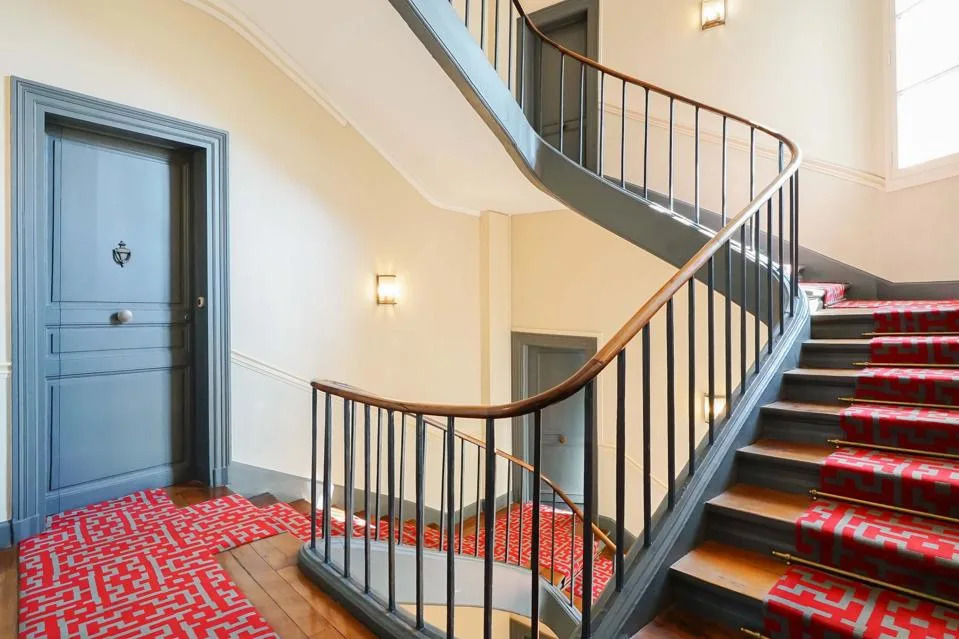 interior stairwell and door to flat at 1 Place de l'Estrapade, Paris, location for Emily in Paris