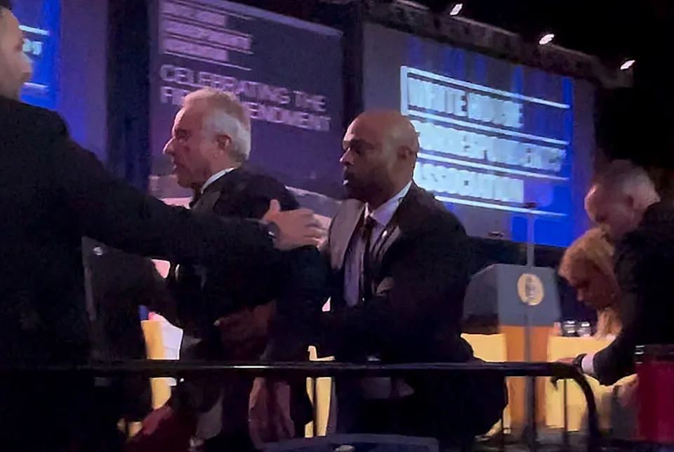 Mark Lodato - PHOTO: Secretary of Health and Human Services Robert F. Kennedy Jr. is rushed out by Secret Service agents after a shooting incident during the White House Correspondents' dinner at the Washington Hilton in Washington, April 25, 2026.