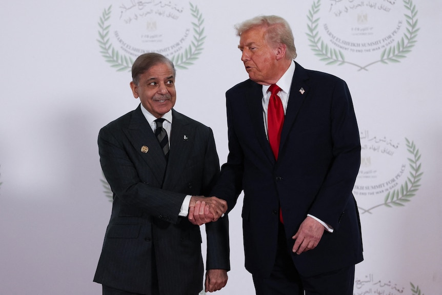 Two men in suit shake hands