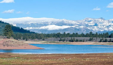How does elevation influence climate change impacts in mountains?