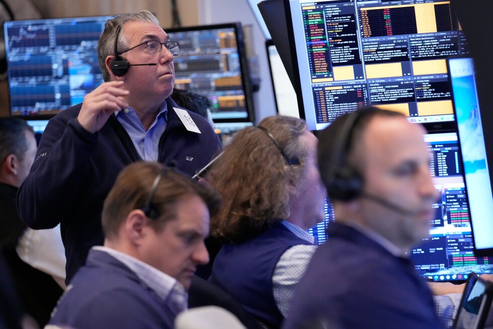 Stocks hover around their records as Wall Street waits for clues about where the Iran war is headed