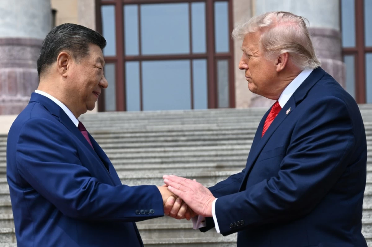 Chinese President Xi Jinping, left, shakes hands with U.S. President Donald Trump at the Great Hall of the People in Beijing, Thursday, May 14, 2026. (Kenny Holston/Pool Photo via AP)