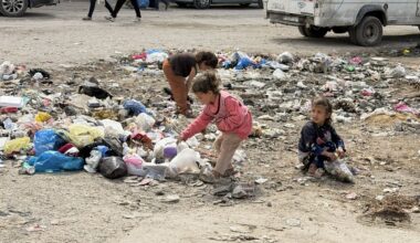 Children rummage through solid waste at a displacement site affected by pests and rodents in Gaza city