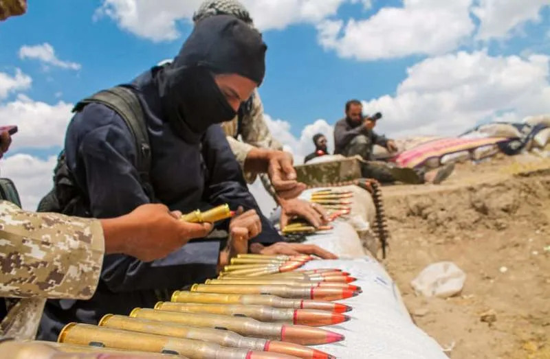 A soldier in an ISIS uniform prepares ammunition. (credit: SHUTTERSTOCK)