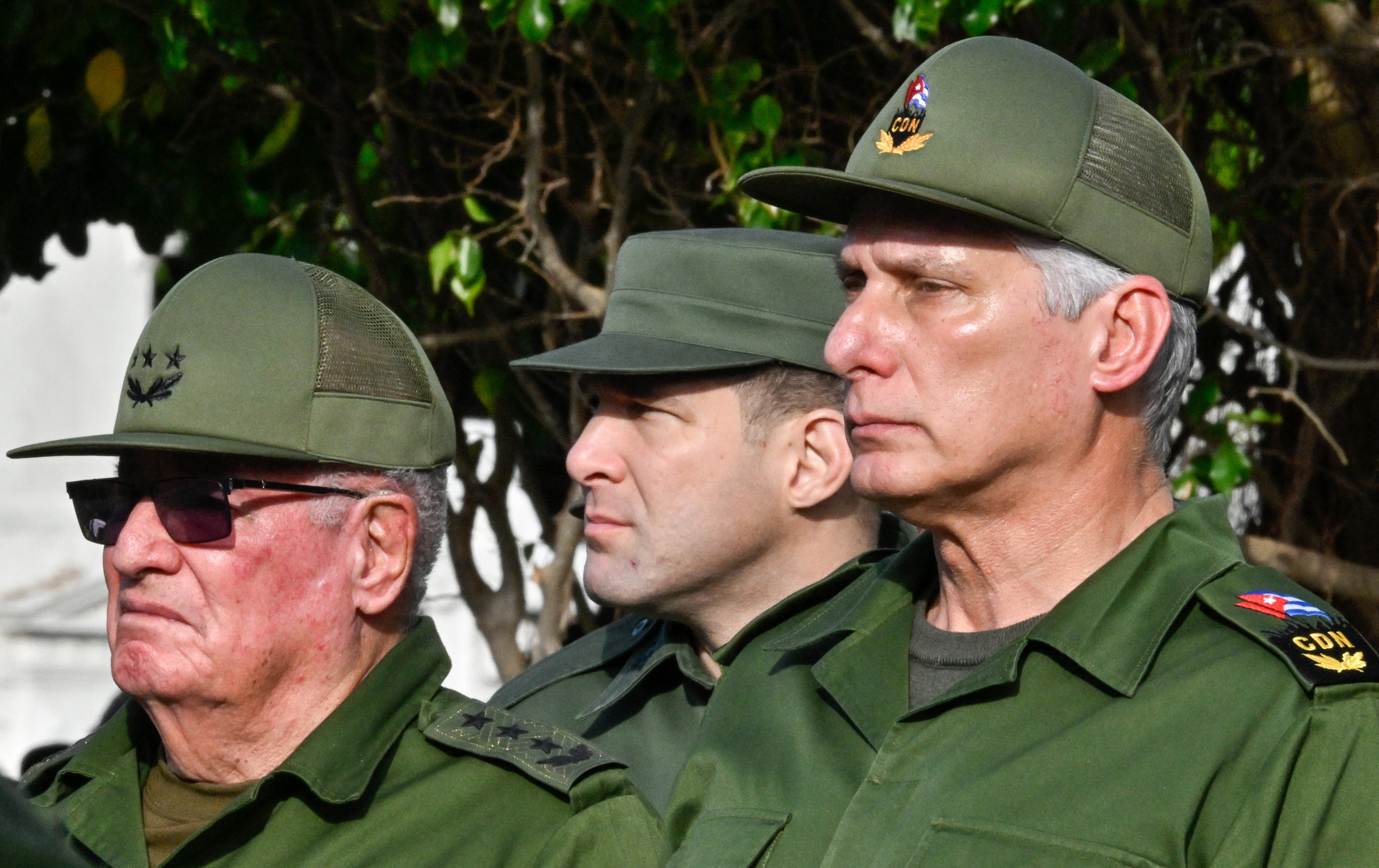 Cuba's President Miguel Diaz-Canel (R), Colonel Raul Guillermo Rodriguez Castro (C), grandson of former President Raul Castro, and Armed Forces Minister General Alvaro Lopez Miera attend the funeral of the 32 Cuban soldiers killed during the US incursion in Venezuela