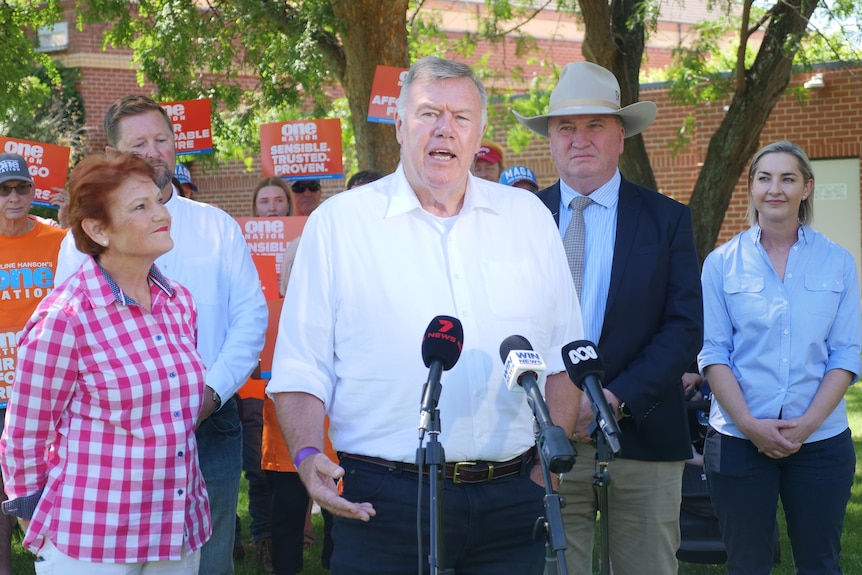 David Farley the new candidate for one nation stands talking to the media flanked by pauline hanson and barnaby joyce