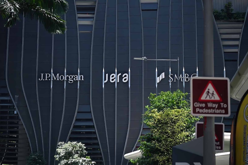 Bank names in white letters on modern buildings in Singapore's finance district.
