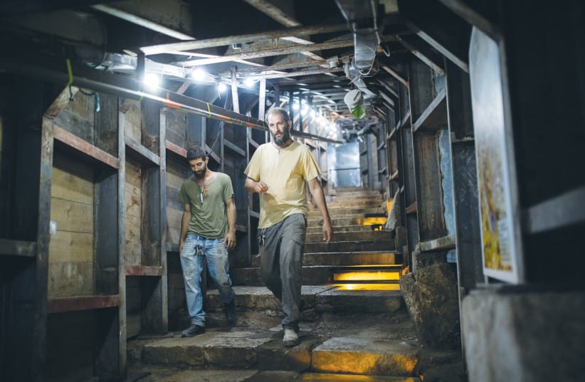 ISRAEL ANTIQUITIES Authority workers walk down the Herodian Street dig at the City of David National Park, in 2019. Also named The Pilgrim’s Way, the street lies beneath Wadi Hilweh street in the Palestinian village of Silwan, and leads from the Siloam Pool to the Temple Mount.