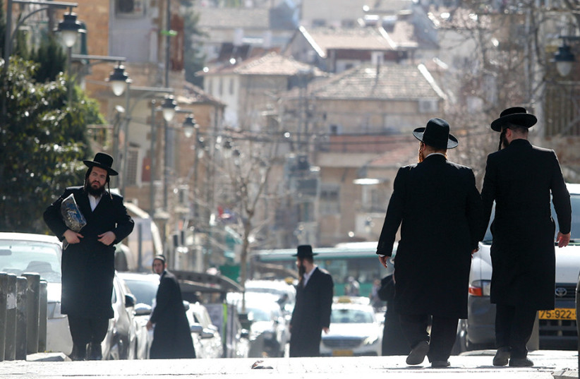 Several haredim (ultra-Orthodox Jews) are seen walking around Jerusalem's Geula neighborhood.