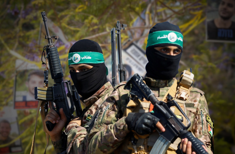 An illustrative photo of Hamas terrorists with hostage demonstrations in the background.