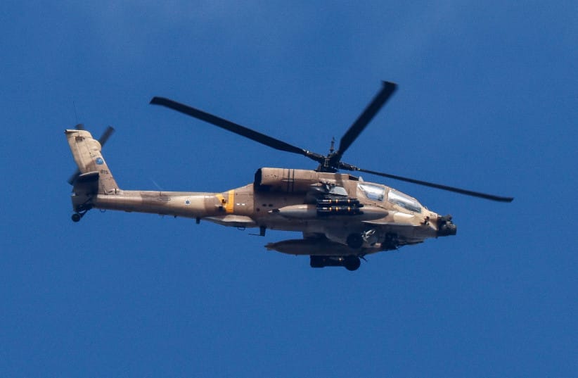 An Israeli Apache military helicopter flies over Gaza, as seen from Israel September 16, 2025.