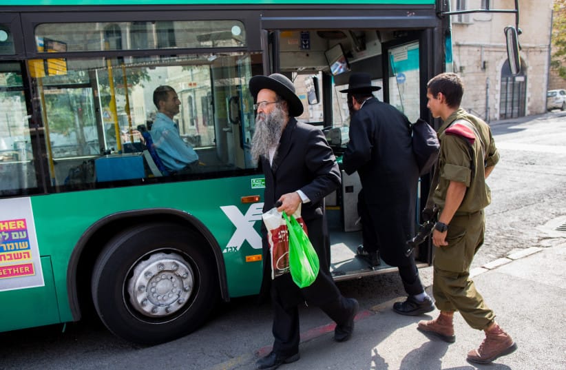 Haredi (ultra-Orthodox) men are seen near a bus in Jerusalem in this photo from 2015.