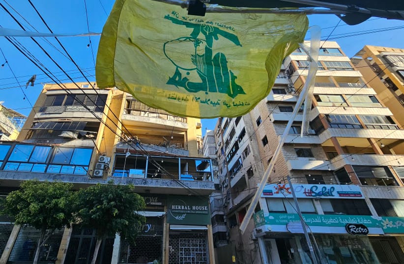 A flag of Hezbollah flutters at the site of damaged buildings following airstrikes in Beirut's southern suburbs of Ghobeiry neighborhood, on March 5, 2026.