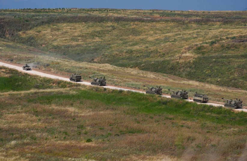 Israeli self-propelled artillery vehicles travel in a convoy toward southern Lebanon near the Israeli-Lebanese border, May 27, 2026.