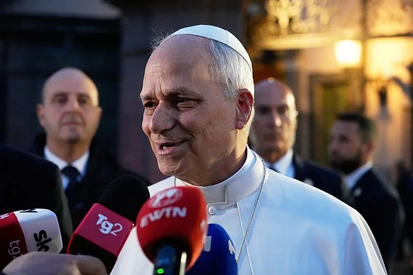 Pope Leo XIV talks to journalists as he leaves his residence in Castel Gandolfo, on the outskirts of Rome, to return to the Vatican, Tuesday, May 5, 2026