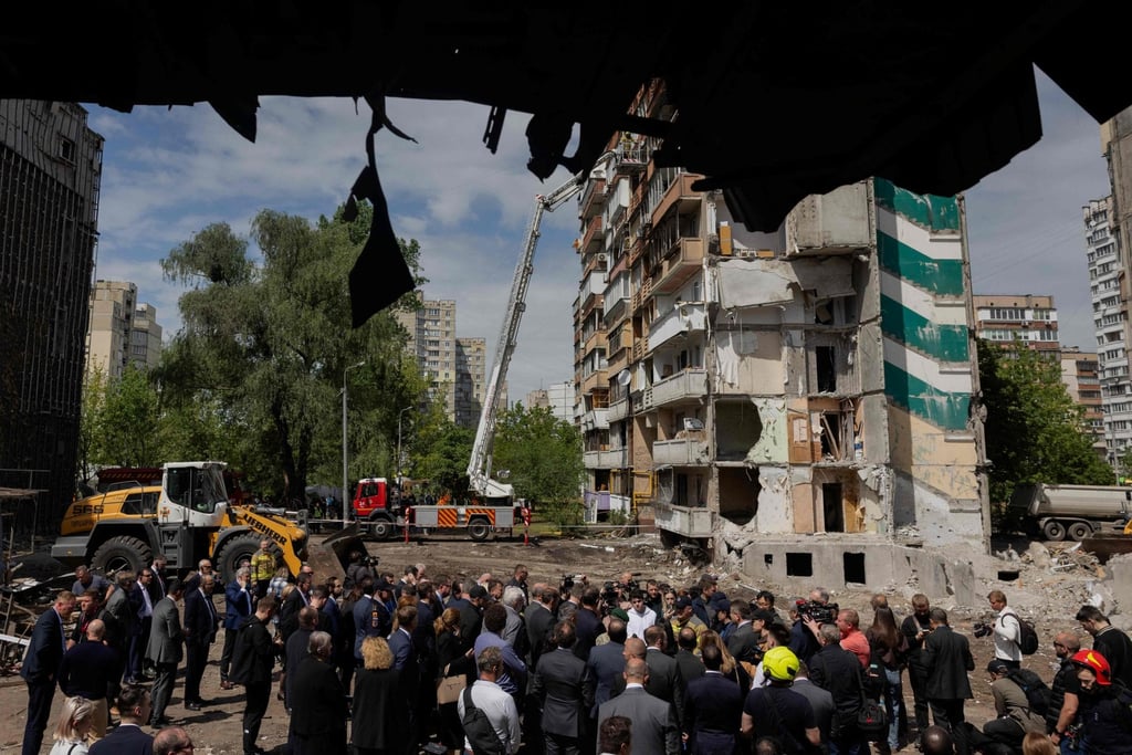 Members of diplomatic missions to Ukraine near a residential building that was partially destroyed following Russian drones and missile strikes in Kyiv on Friday. Photo: AFP Members of diplomatic missions to Ukraine near a residential building that was partially destroyed following Russian drones and missile strikes in Kyiv on Friday. Photo: AFP