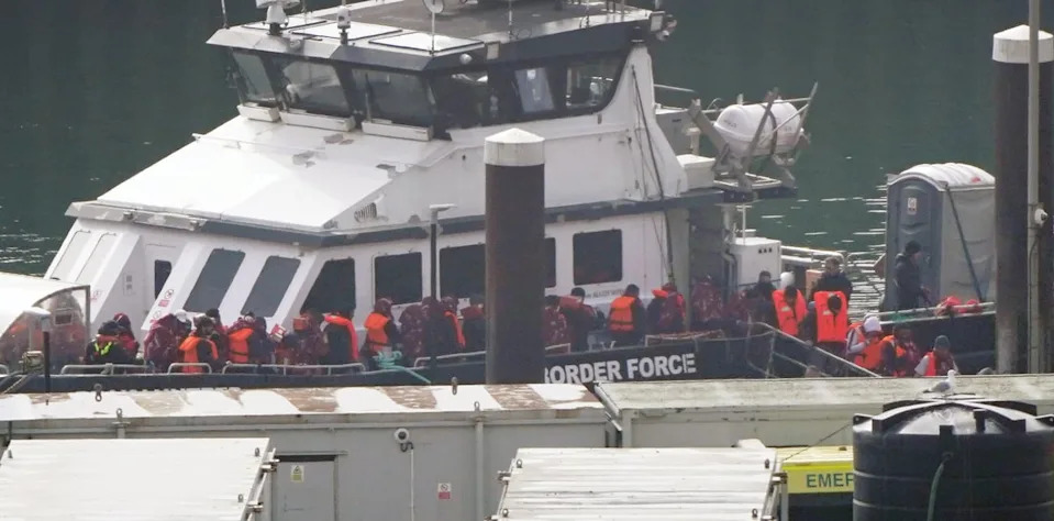 A group of people thought to be migrants are brought in to the Border Security Command compound in Dover, Kent (PA)