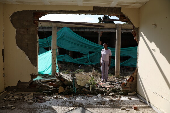 Eucaris Zamora stands in front of her home destroyed during an attack involving drones by a dissident branch of the former Revolutionary Armed Forces of Colombia, or FARC, guerrilla group in Robles, Colombia, Tuesday, May 19, 2026.(AP Photo/Santiago Saldarriaga)