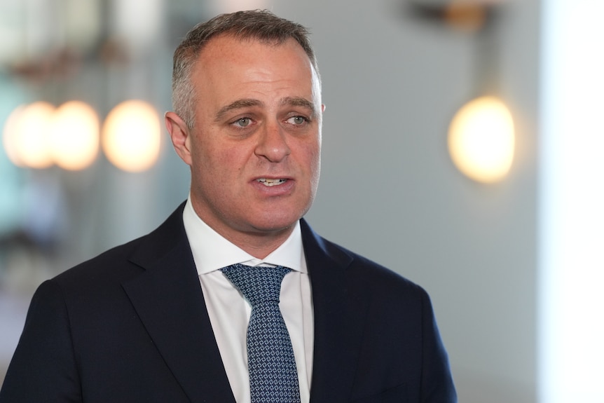 A man in a suit talking to journalist