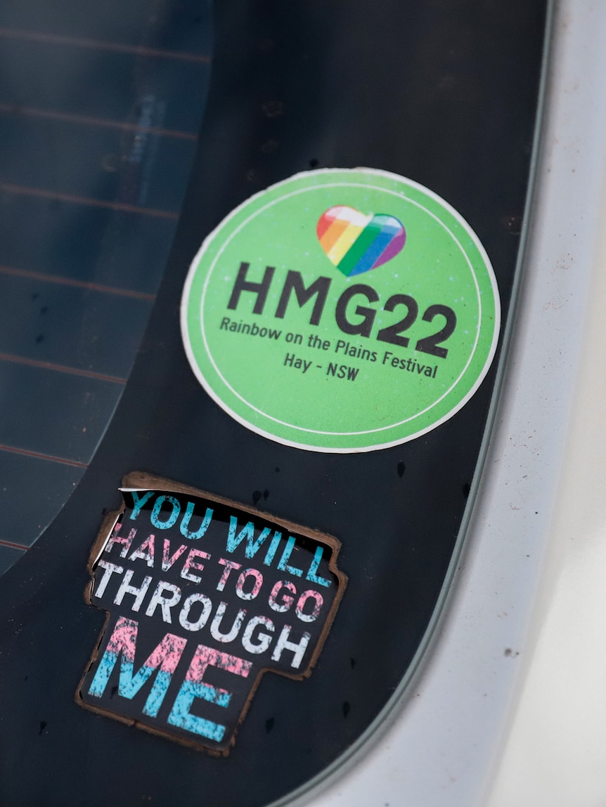 Stickers on the back windscreen of a white hatchback expressing support for LGBTIQ+ rights