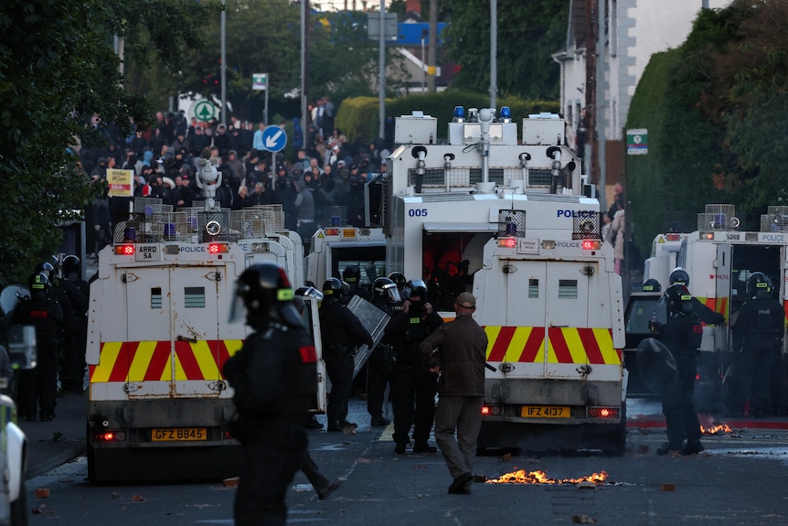 Police block a road to stop anti-immigrant protesters in belfast