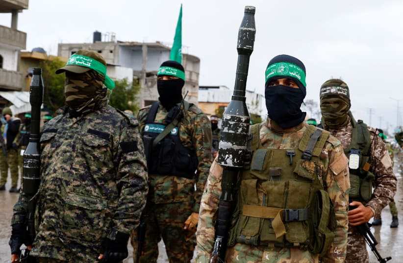 Palestinian Hamas terrorists stand guard on the day of the handover of hostages held in Gaza since the deadly October 7 2023 attack, as part of a ceasefire and a hostages-prisoners swap deal between Hamas and Israel, in Rafah in the southern Gaza Strip, February 22, 2025.