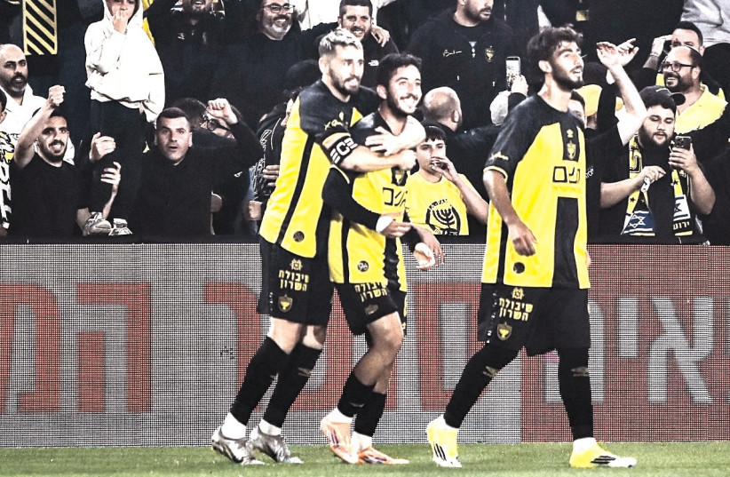 BEITAR JERUSALEM players celebrate amid a roaring Teddy Stadium crowd as the capital club has surged into first place in a thrilling and tightly contested title race.
