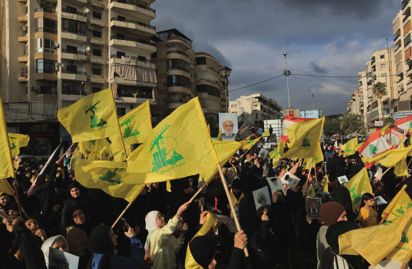 People hold Hezbollah flags while commemorating Israel’s withdrawal from southern Lebanon in 2000, in the southern suburbs of Beirut, Lebanon, May 25, 2026.