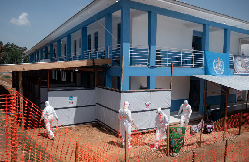  DRCONGO-HEALTH-EBOLA EDITORS NOTE: Graphic content / Medical staff walk towards the doffing and decontamination station at the Evangelical Medical Center of Nyankunde (CME) after providing care to patients suffering from or suspected of having Ebola virus disease in Bunia, Ituri Province, Democrati (credit: Jospin Mwisha / AFP via Getty Images)