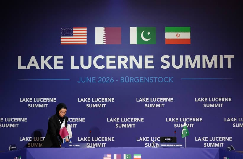A member of the Qatari delegation makes adjustments ahead of a quadrilateral meeting between the U.S., Iran, Pakistan, and Qatar at the Lake Lucerne Summit, June 21, 2026.