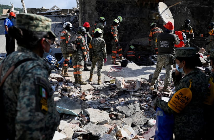 Rescue personnel work as rescue operations continue after earthquakes hit the country, in La Guaira, Venezuela, June 27, 2026.