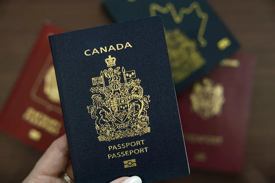 A hand holding a Canadian passport in Vancouver, Canada, on March 18, 2025.