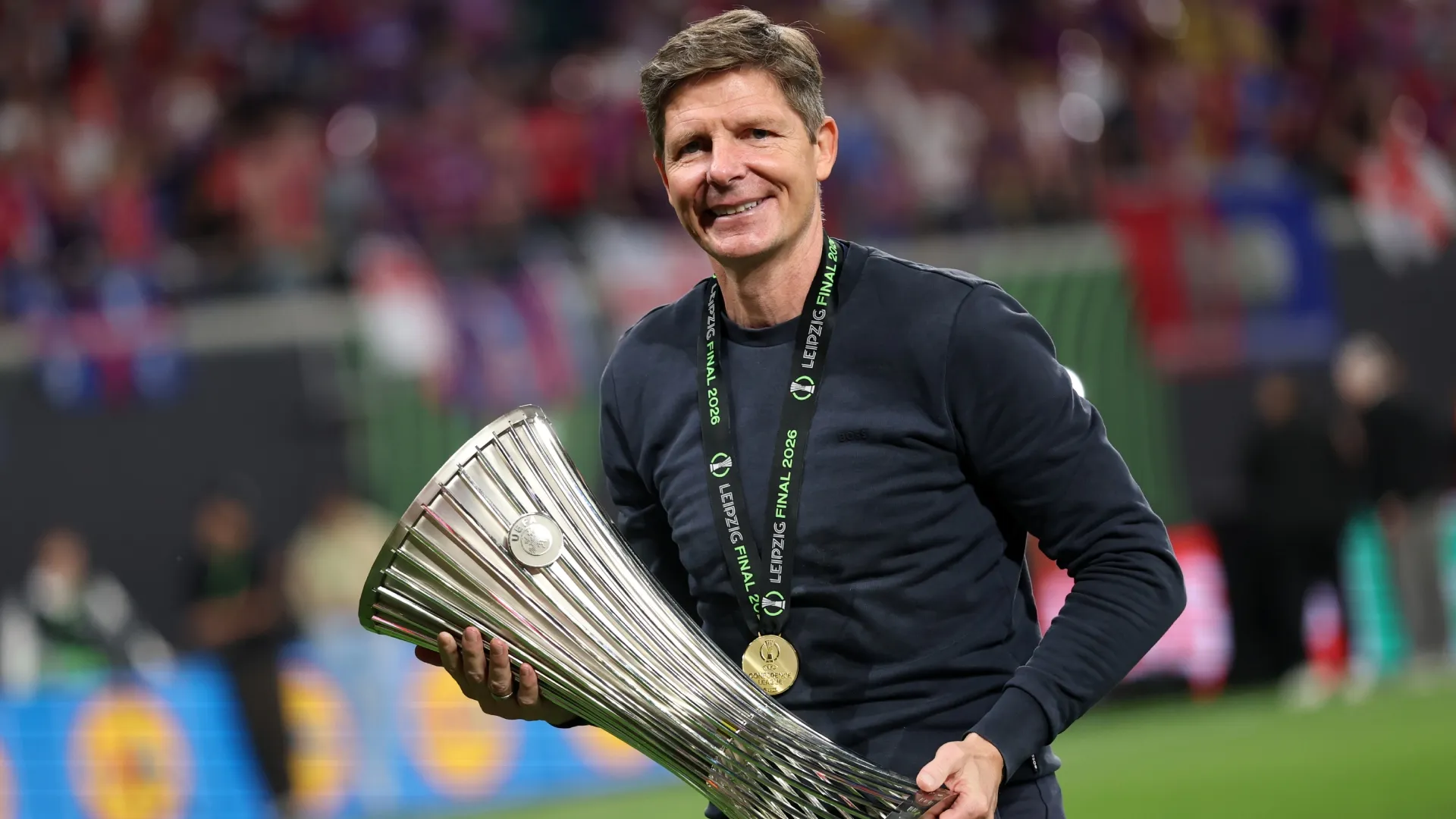 Oliver Glasner, Manager of Crystal Palace, celebrates with the UEFA Conference League Trophy.