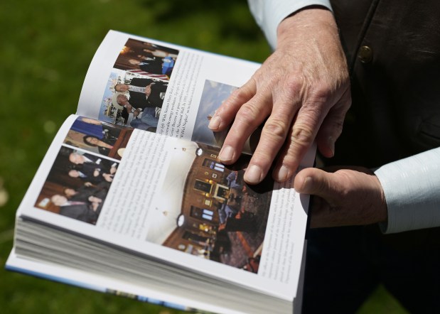 Ken Salazar, former U.S. senator, secretary of the interior, and U.S. ambassador to Mexico, thumbs through a copy of his new book, Borderlands: My Fight for an Inclusive America, outside his home on June 15, 2026, in Denver. (Photo by RJ Sangosti/The Denver Post)