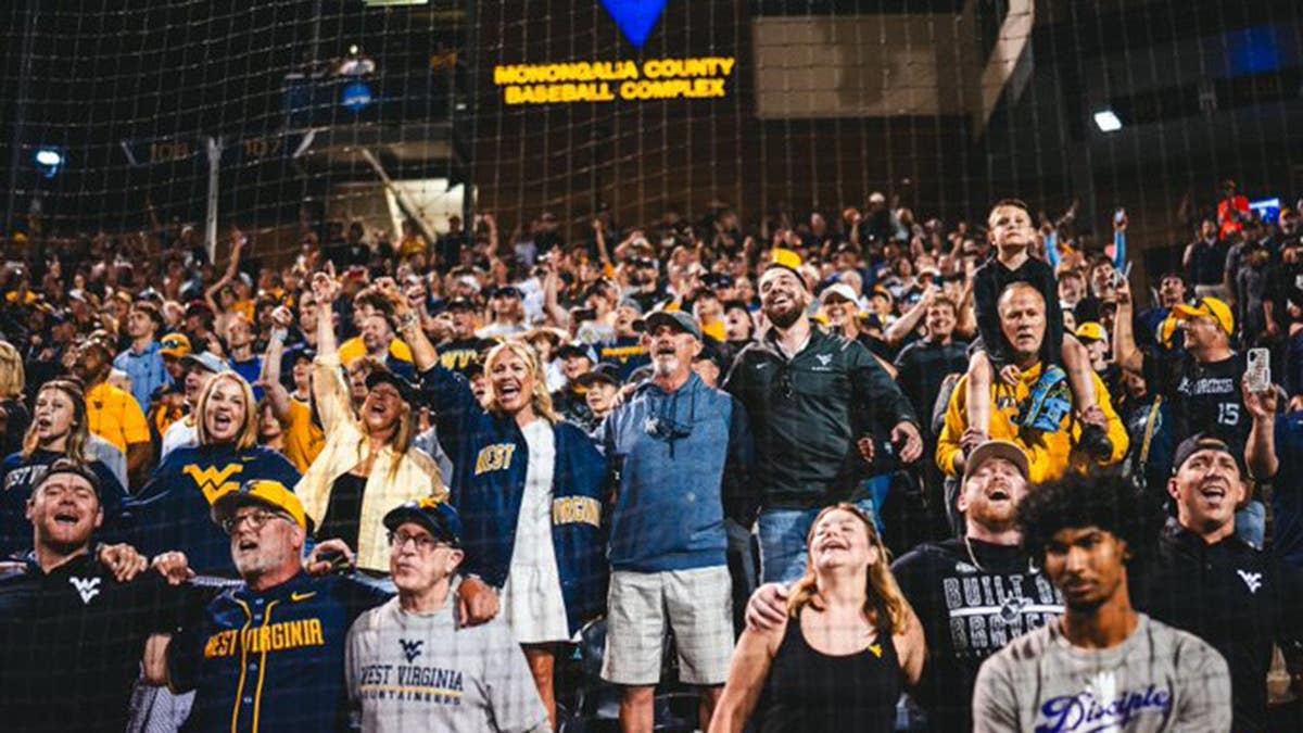West Virginia fans celebrate the Mountaineers defeating Kentucky for a spot in the NCAA Tournament Super Regional