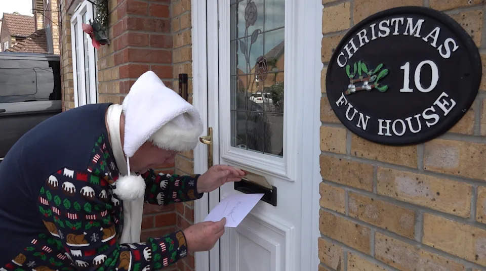 Andy posts his Christmas cards through his own front door