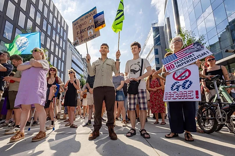 Protestors demonstrate against the America 250 event taking place in the Cinquantenaire Park in Brussels, Sunday, June 28, 2026.