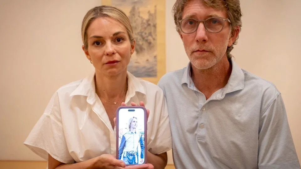Nancy and Keith Higginbotham show a picture of their 20-year-old son James, who goes by “Weston.” - Clipped From Video