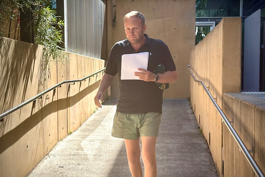 Man in shorts and shirt walking down ramp