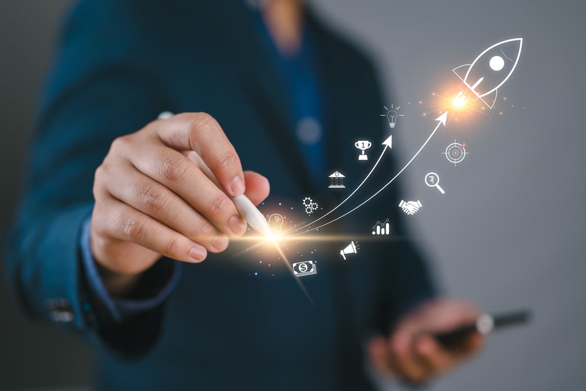 A person pointing to a chart with a growth trend.